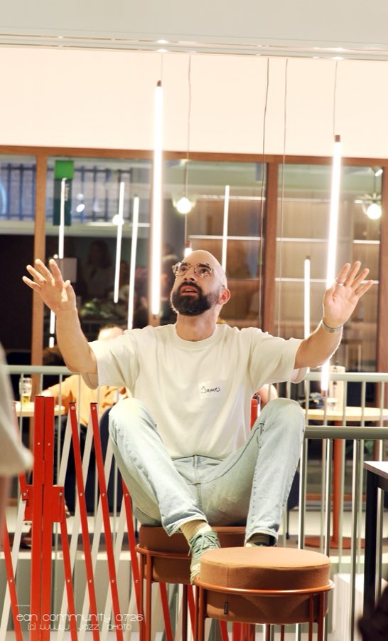 A man gesturing mid-conversation