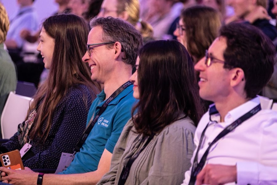 Audience members laughing during a talk