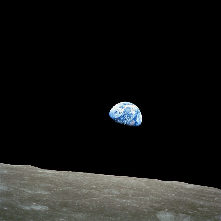 Earth rising over the Moon's horizon