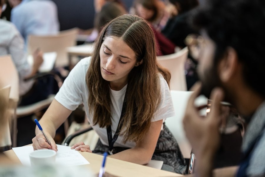 An attendee taking notes during a session